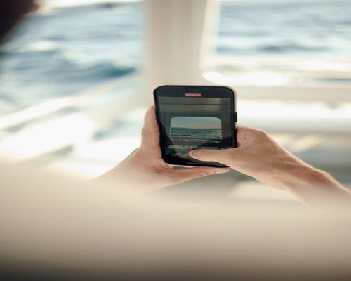 Main smartphone showing the fictional Turbo Crown Voyager arcade adventure